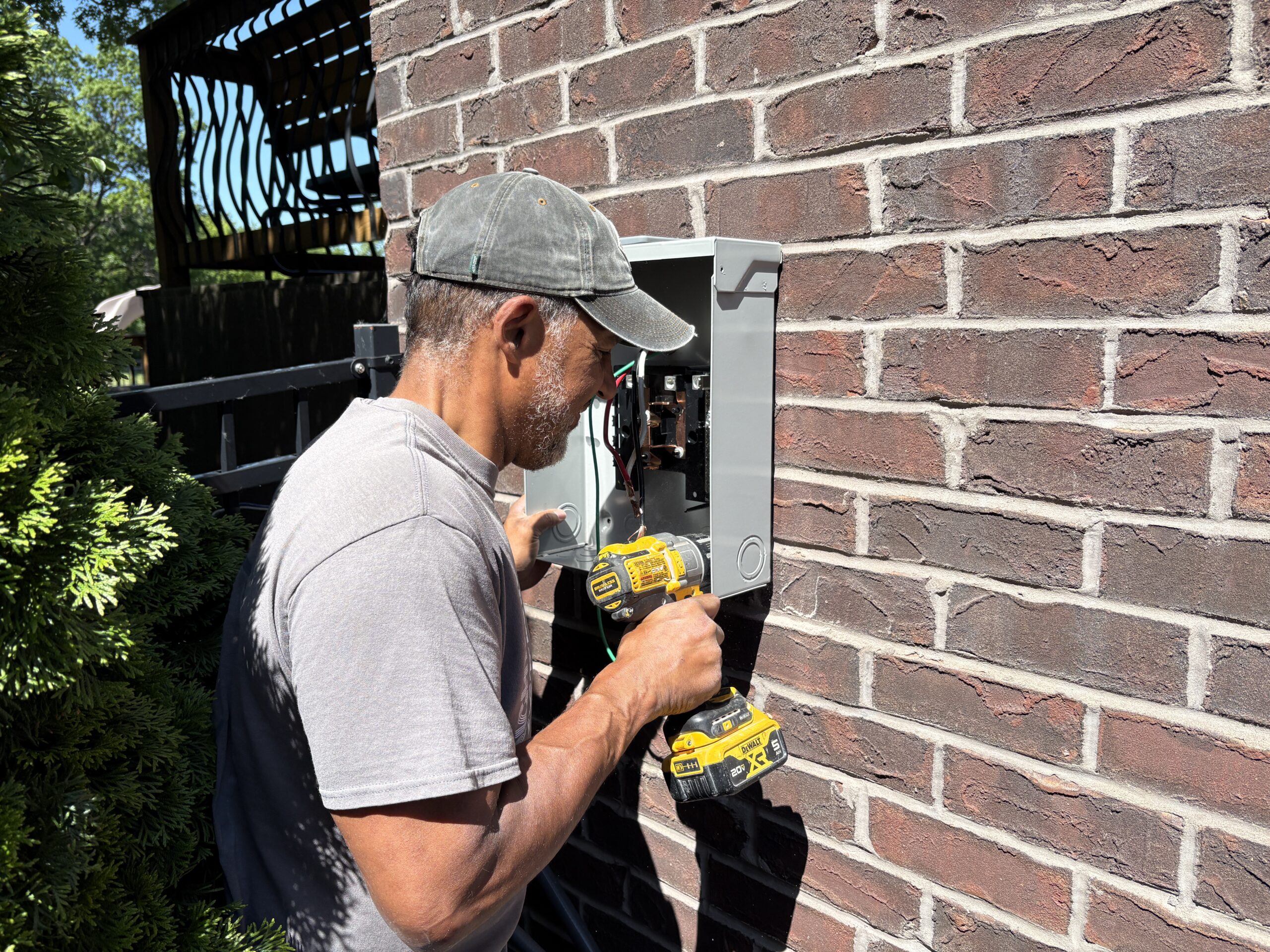 Electrician testing voltage levels on a newly wired residential breaker panel.